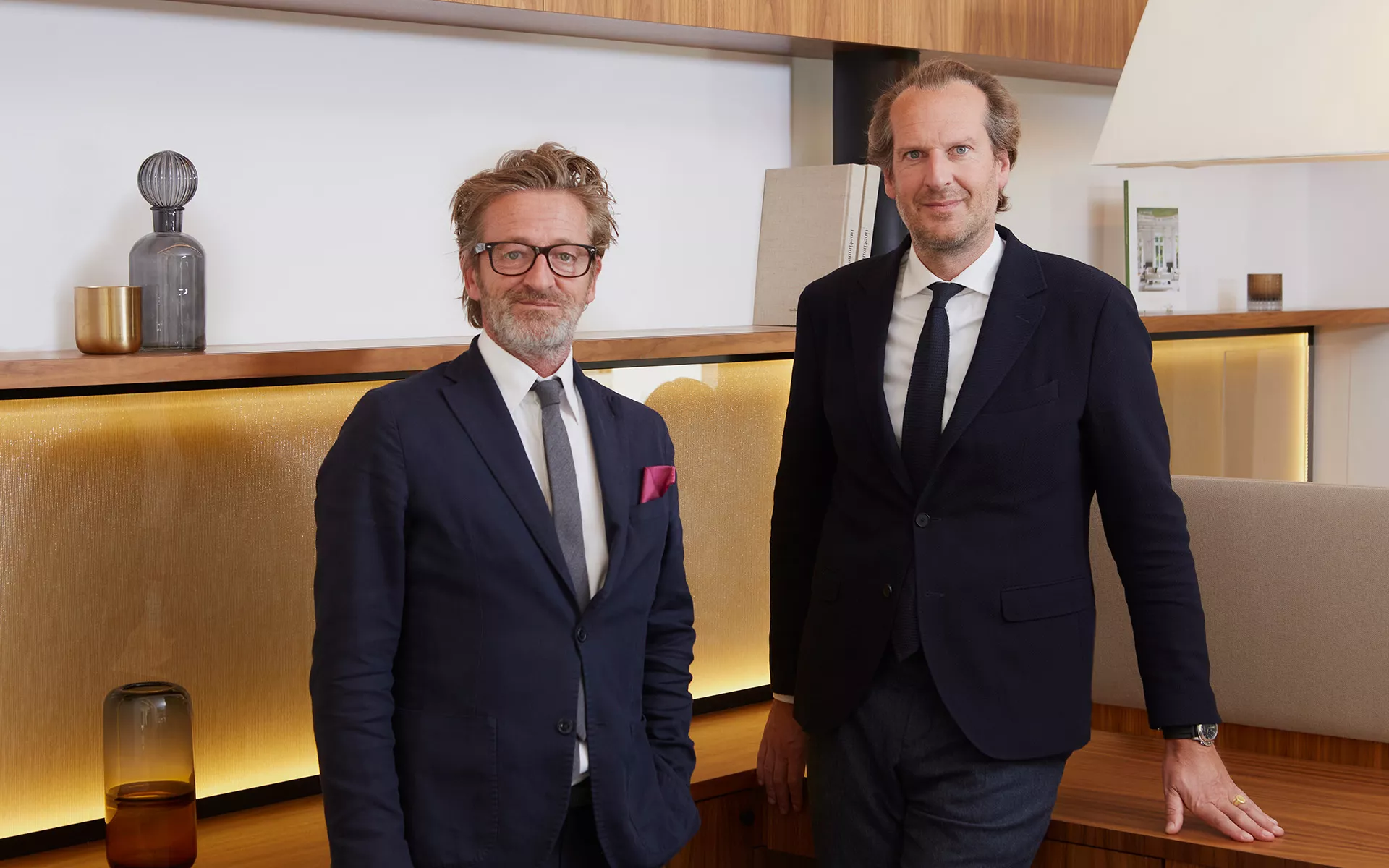 The two directors of Junot Buildings are photographed in a Junot luxury estate agency