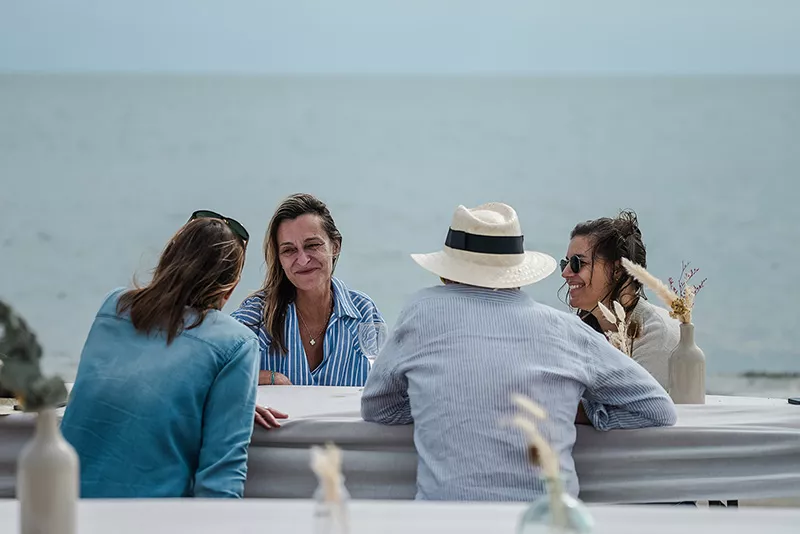 Junot team chatting on the beach during a Junot seminar